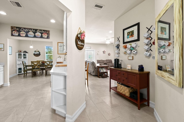 hallway featuring light tile patterned floors