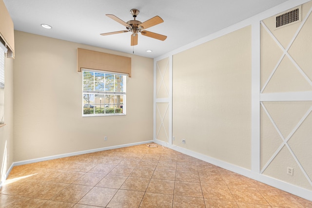 tiled spare room with ceiling fan