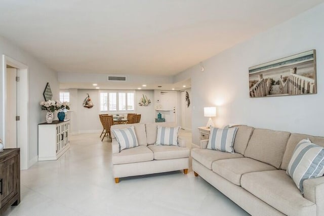 living room with baseboards, visible vents, and recessed lighting