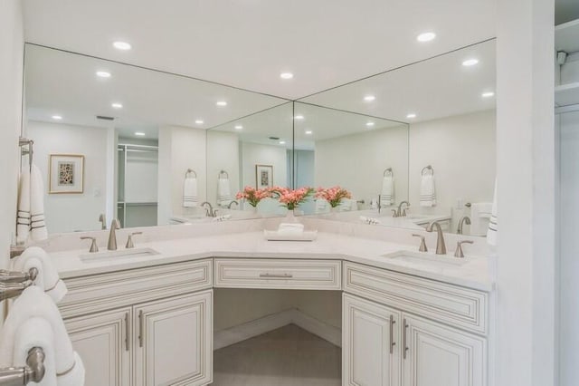 bathroom featuring recessed lighting, an enclosed shower, a sink, and double vanity