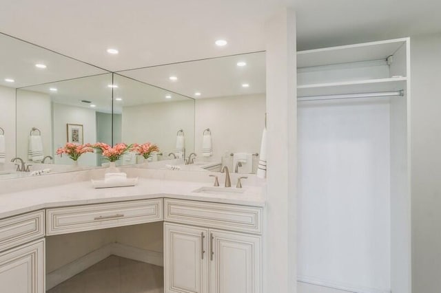 bathroom featuring recessed lighting and vanity