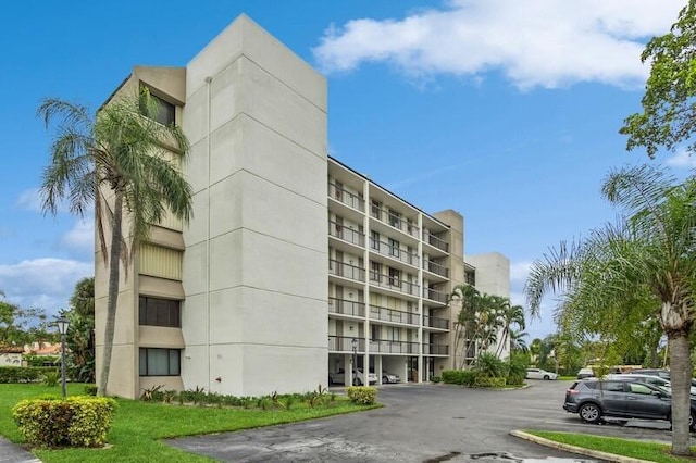 view of building exterior with uncovered parking