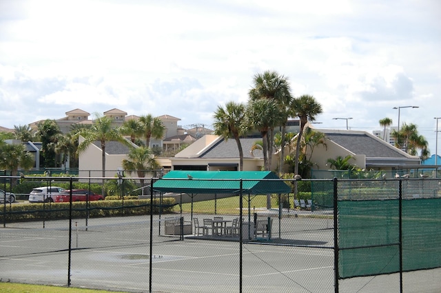 view of sport court featuring a residential view and fence