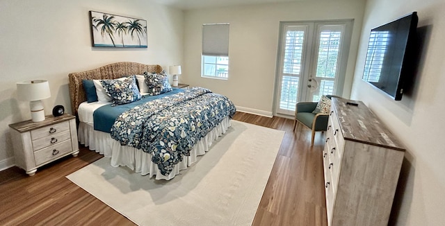 bedroom featuring dark wood-type flooring and access to outside