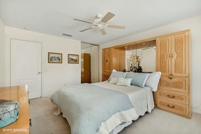 bedroom featuring light carpet, a closet, and ceiling fan