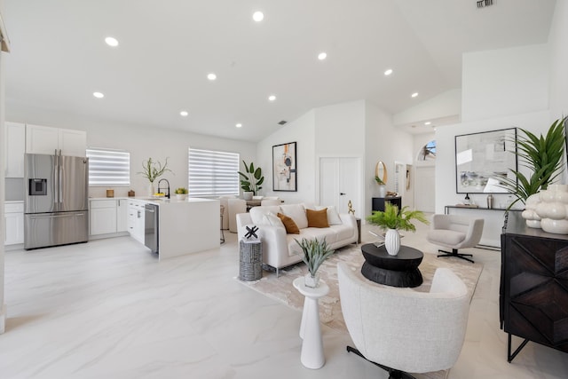 living room featuring sink and high vaulted ceiling