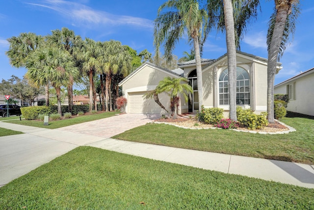 view of front of home with a front yard and a garage