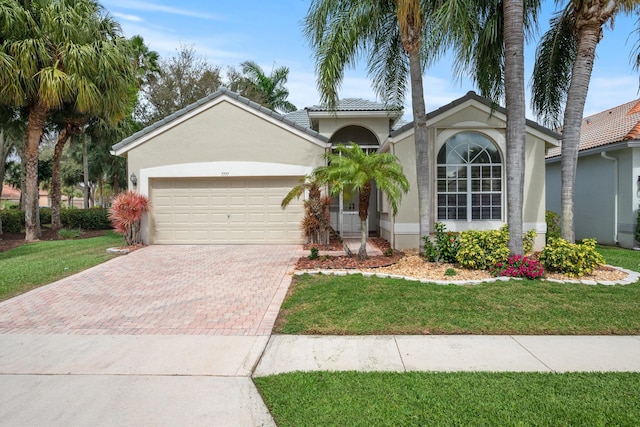 view of front of property with a garage and a front yard