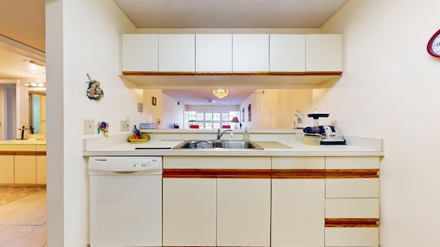 kitchen featuring sink, light tile patterned floors, white cabinets, and dishwasher