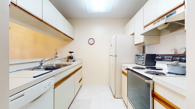 kitchen with sink, white appliances, and white cabinets