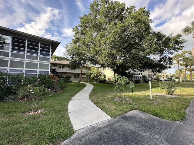 view of home's community with a yard