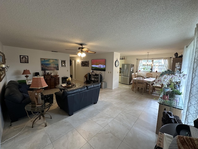 living area featuring a ceiling fan, a textured ceiling, and light tile patterned flooring