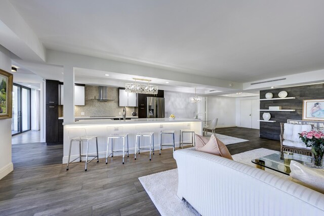 living area with a chandelier, dark wood-style floors, and recessed lighting