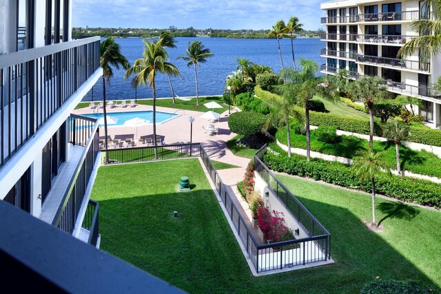 view of property's community featuring a water view and a lawn