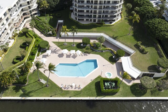 bird's eye view of a pool area and apartment complex