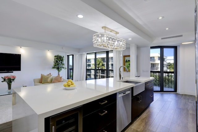 kitchen with a sink, dishwasher, a spacious island, modern cabinets, and plenty of natural light