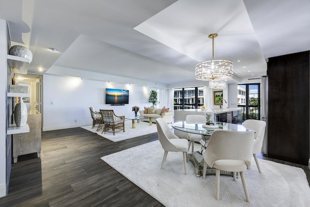 dining room with a chandelier, dark wood-style floors, baseboards, and recessed lighting