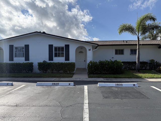 single story home with uncovered parking and stucco siding