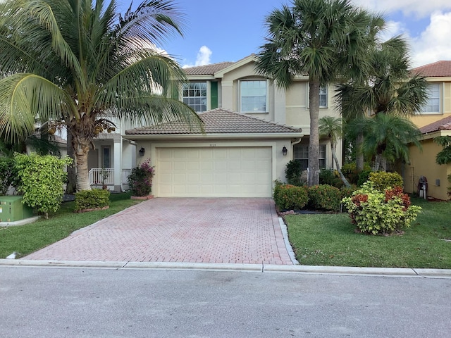 view of front of property with a garage and a front yard