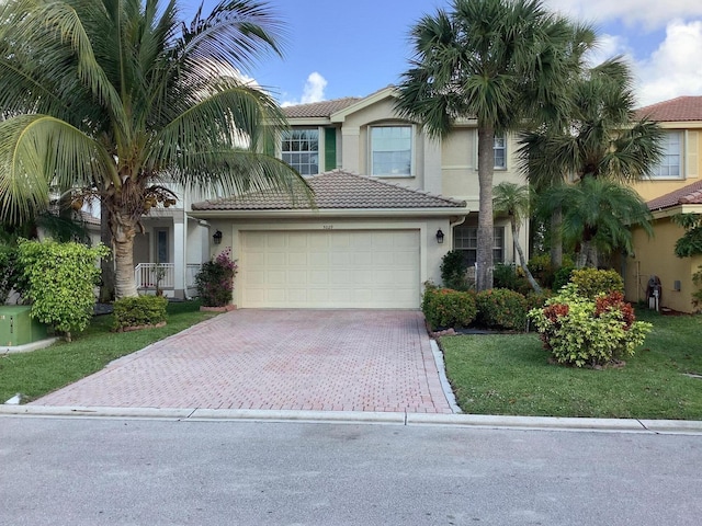 view of front of property featuring a garage and a front lawn