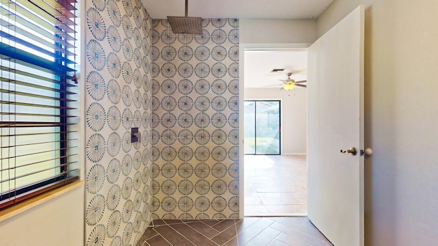 bathroom featuring ceiling fan and tiled shower