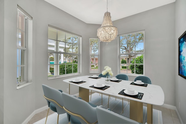 dining room featuring a chandelier, light tile patterned floors, baseboards, and a healthy amount of sunlight