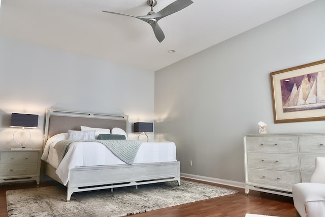 bedroom with lofted ceiling, ceiling fan, baseboards, and wood finished floors