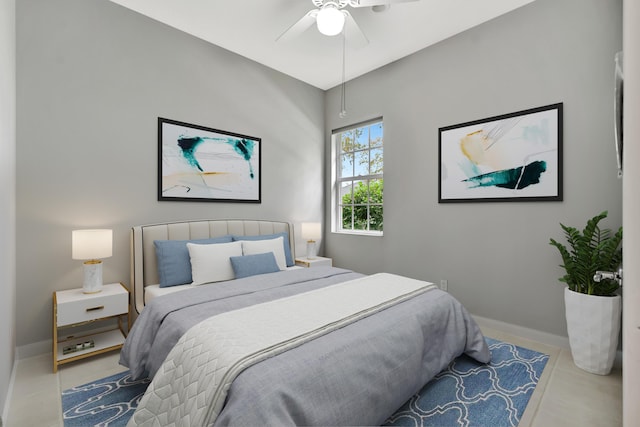 bedroom with light tile patterned floors, ceiling fan, and baseboards