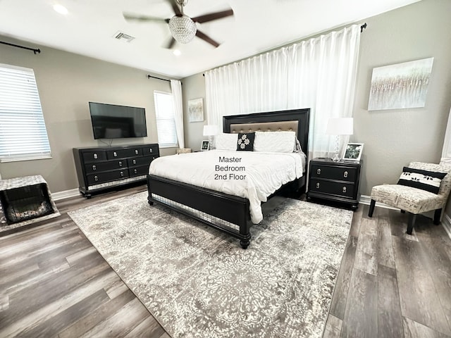 bedroom with hardwood / wood-style flooring and ceiling fan