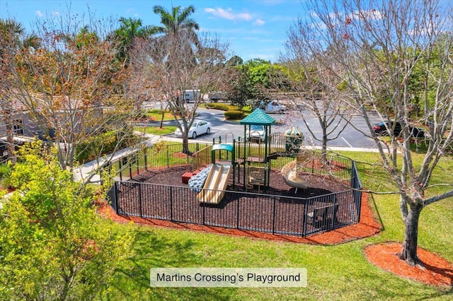 community play area with fence and a lawn