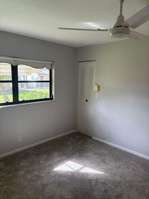 carpeted spare room with baseboards