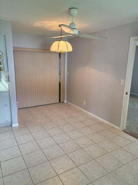 unfurnished room featuring baseboards and light tile patterned floors