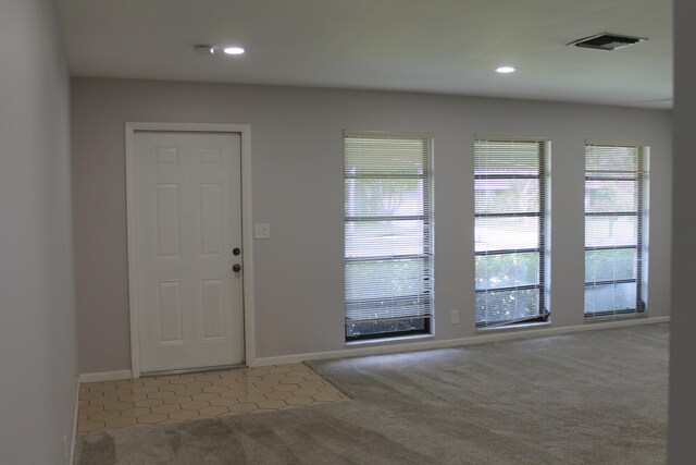 kitchen with under cabinet range hood, white appliances, a sink, white cabinetry, and light countertops