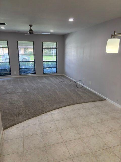 unfurnished room featuring recessed lighting, light carpet, a ceiling fan, visible vents, and baseboards