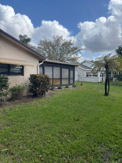 view of yard featuring a sunroom