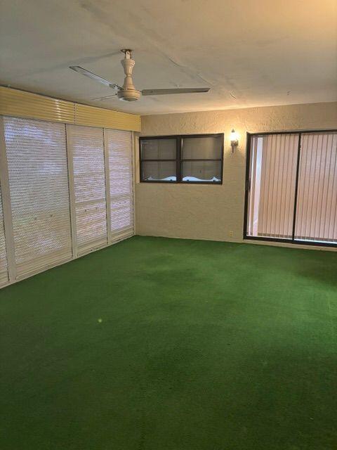 unfurnished sunroom featuring a ceiling fan