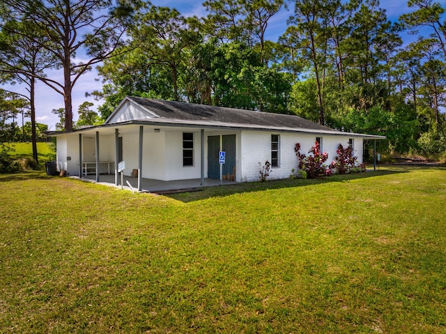 back of property with a yard and a patio