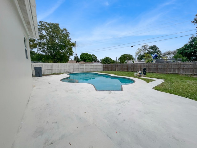 view of pool with a yard and a patio