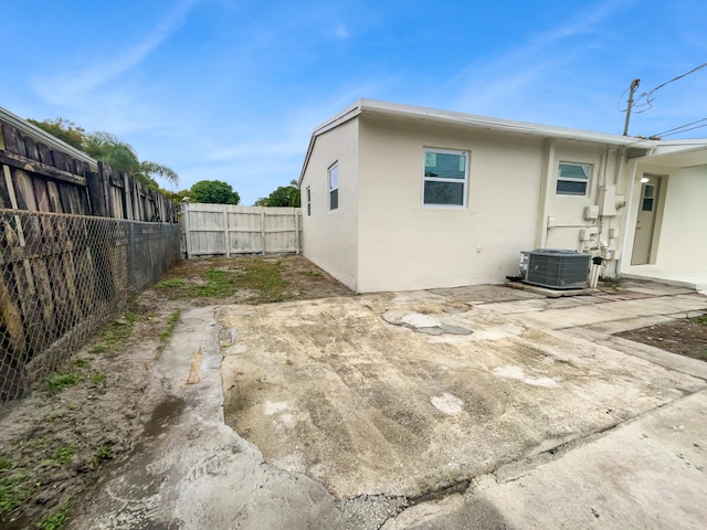 exterior space featuring central air condition unit and a patio