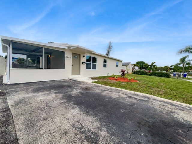 ranch-style home with a front lawn