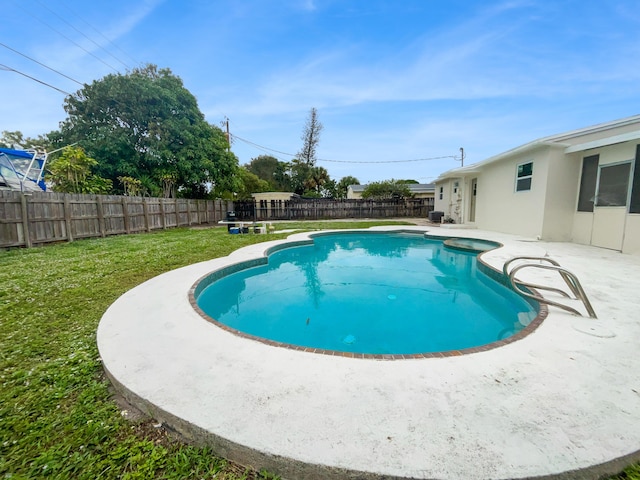 view of swimming pool featuring a patio area and a lawn