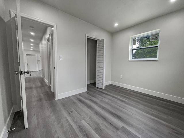 unfurnished bedroom featuring dark hardwood / wood-style floors and a closet