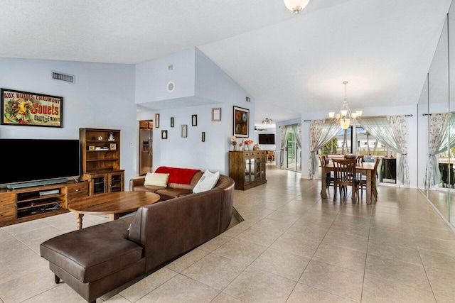 living room featuring a chandelier, high vaulted ceiling, visible vents, and light tile patterned floors