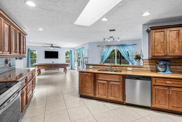 living area featuring a textured ceiling, vaulted ceiling, and visible vents