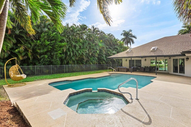 view of pool with a pool with connected hot tub, a patio area, a fenced backyard, and an outdoor living space