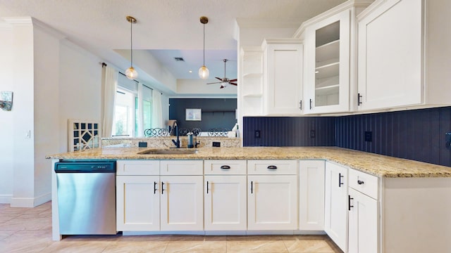 kitchen featuring sink, dishwasher, pendant lighting, and white cabinets