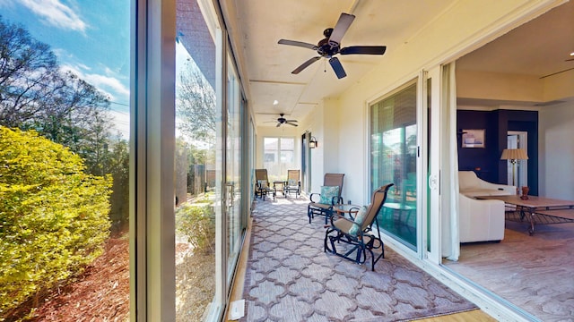 sunroom featuring ceiling fan