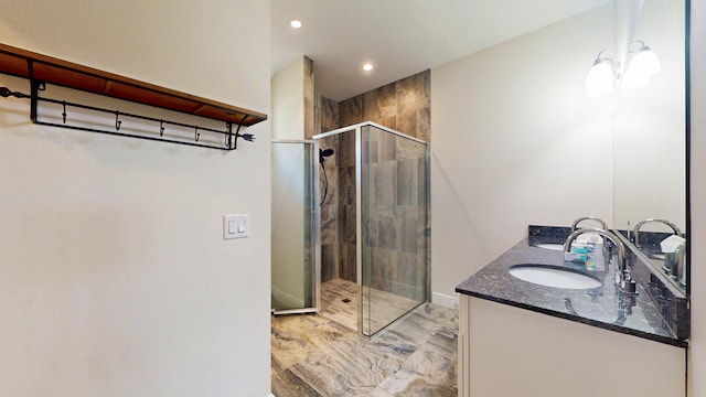 bathroom featuring an enclosed shower and vanity