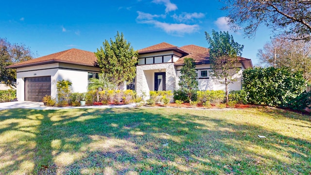 view of front facade with a front yard and a garage