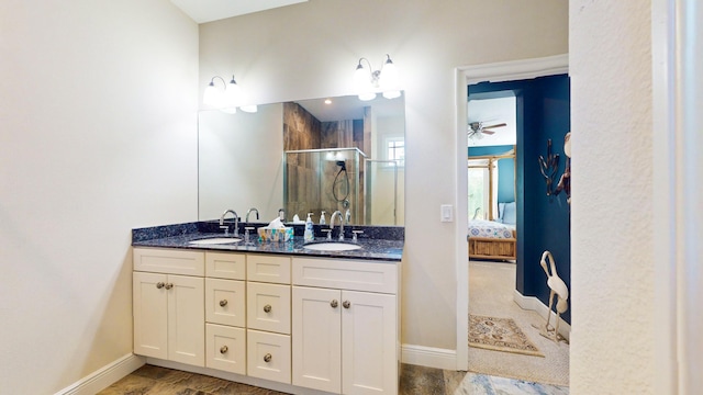 bathroom with vanity and a shower with shower door